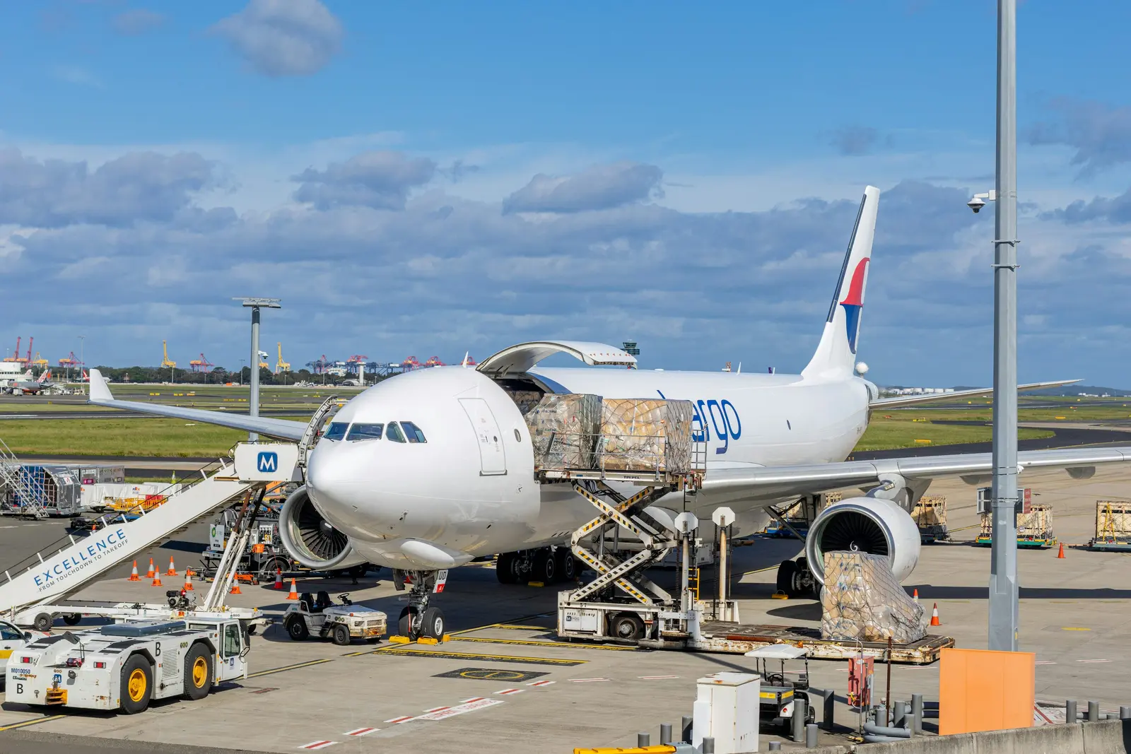 Home Cargo aircraft being loaded with freight at an airport